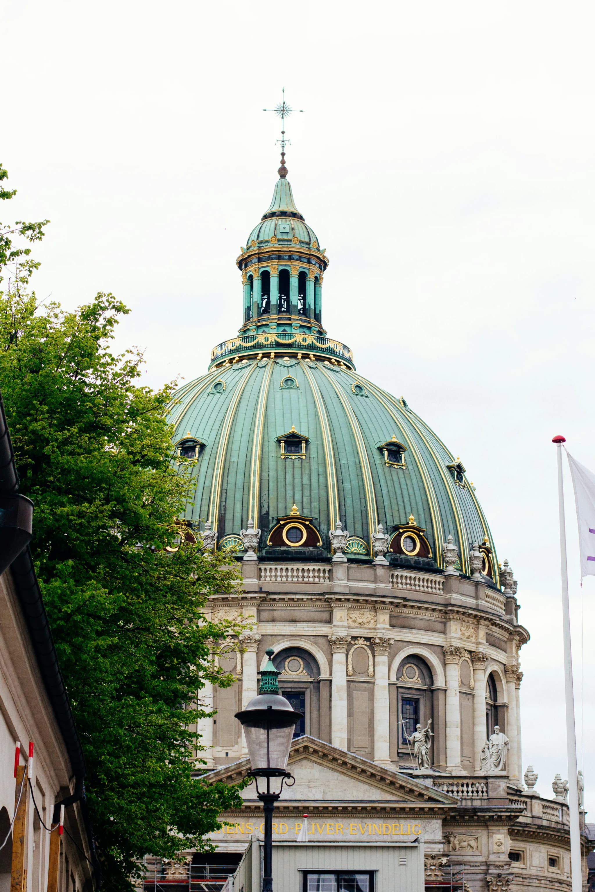 The green copper dome of the Marble Church seen from the street in Copenhagen