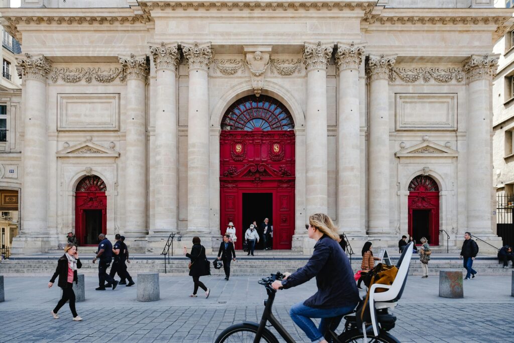 Urban scene in Copenhagen featuring people and classic architecture with red doors.