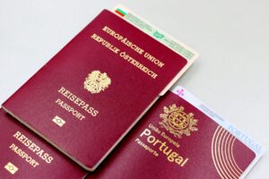 A close-up image of Austrian and Portuguese passports with a Bulgarian ID card.