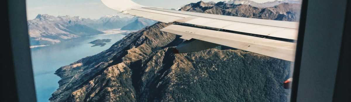 Stunning aerial view of mountains and sea from an airplane window.